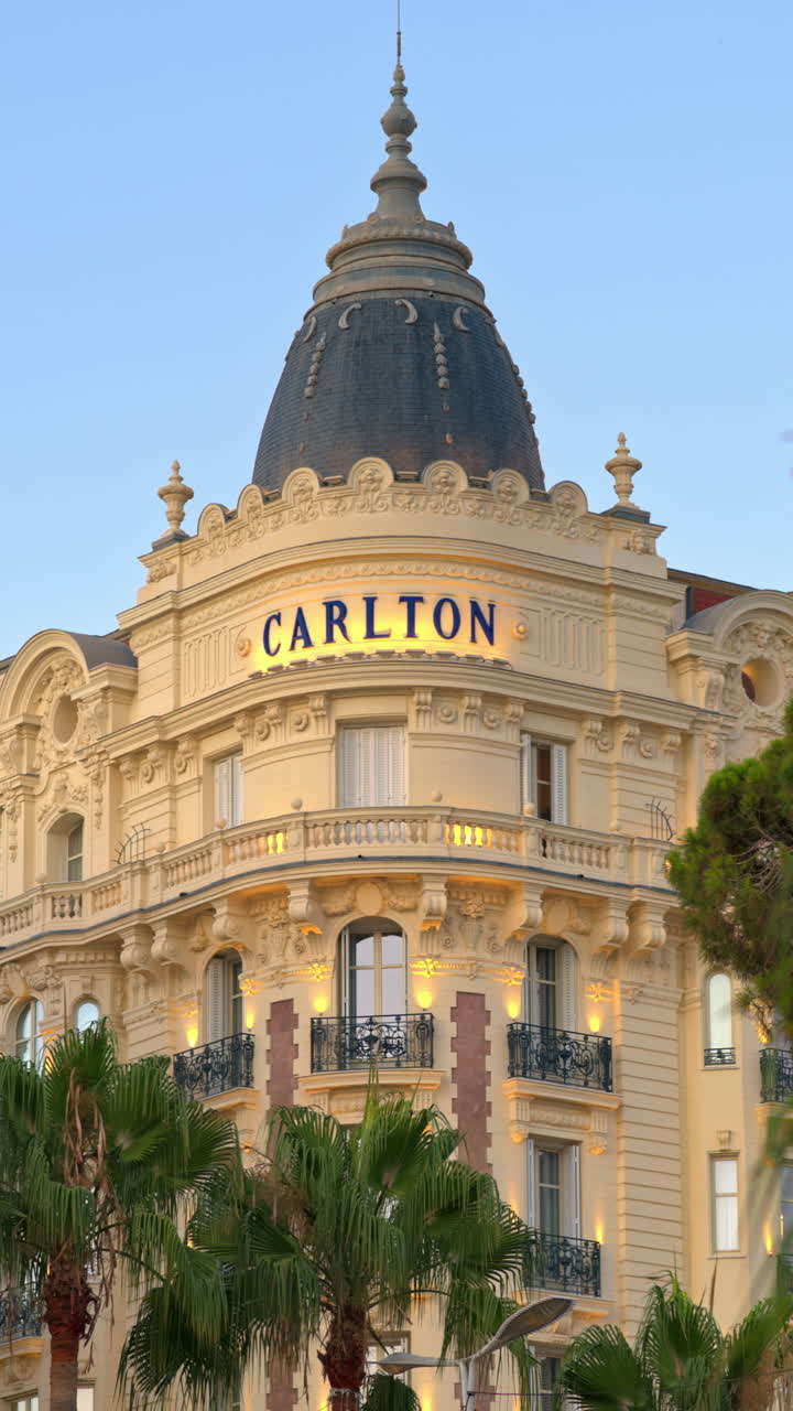 Cannes, France - July 15, 2024: View of the Carlton Hotel on the coast in the evening. Vertical