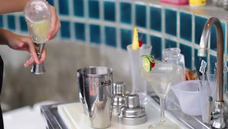 bartender prepares a refreshing lime cherry cocktail