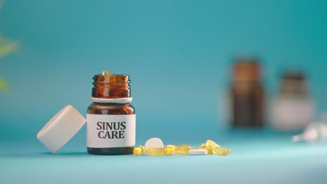 hand taking out sinus care tablets from medicine bottle