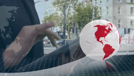 animation of red and white globe and map, over businesswoman in street using tablet