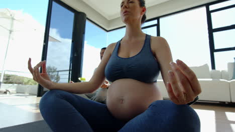 pregnant woman meditating in yoga pose, focusing on relaxation and mindfulness