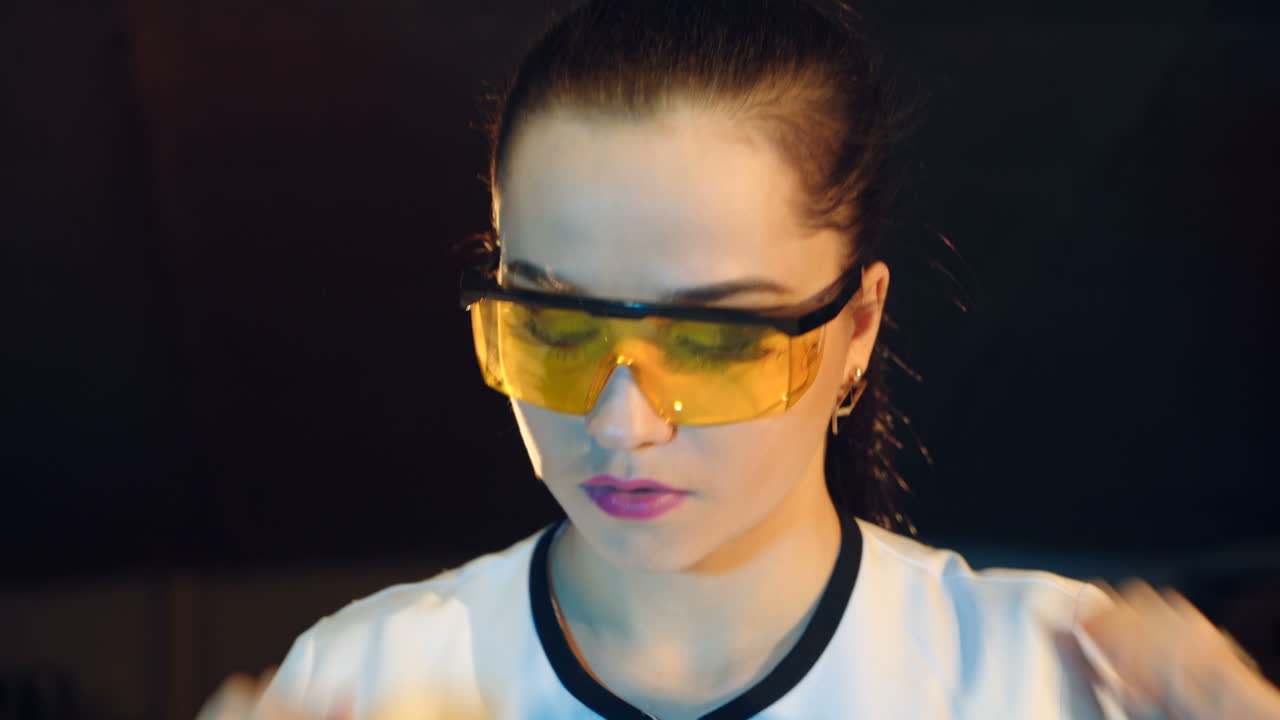 Woman scientist mixing together two liquid substances. Scientific discoveries.