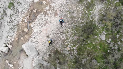 Canyoners-walking-through-the-rocky-river-bed