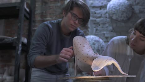 pottery students working on sculptures in an art studio