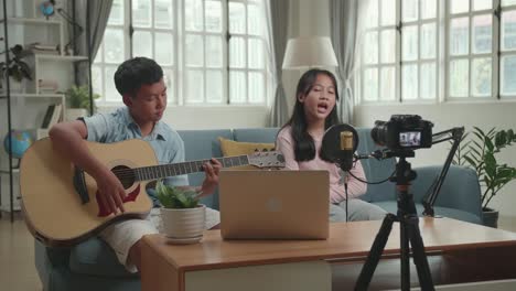 kids singing and playing guitar at home