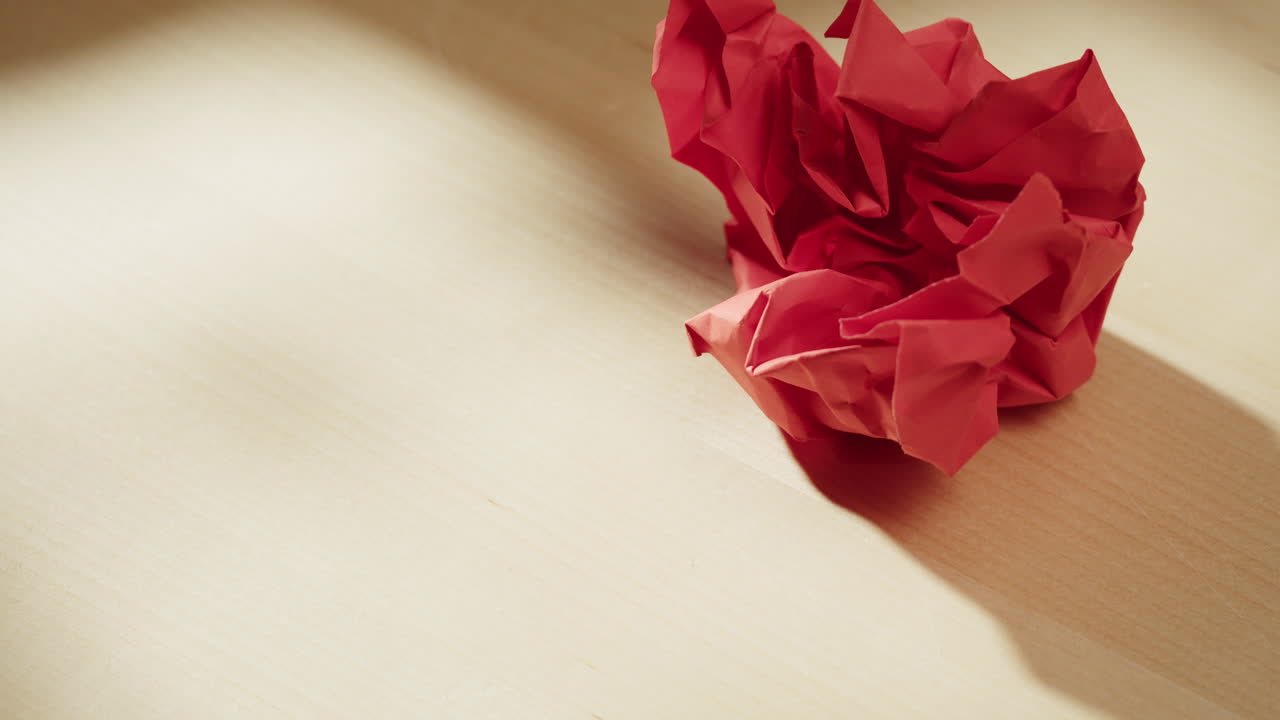 Red Crumpled Paper on Desk
