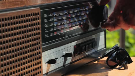 old retro am fm radio with tubes, hand changing stations , bulb vintage music player.