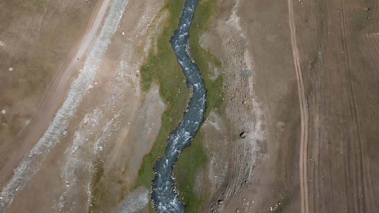 Scenic aerial view of a river flanked by parallel roads