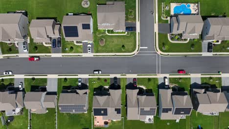 aerial top down shot of american neighborhood with houses with rooftop solar panel arrays