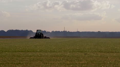 large farming tractor early morning sunrise on commercial farm