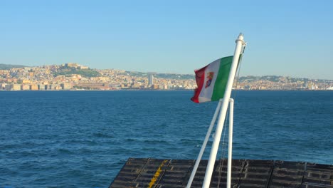 italian flag at the back of boat waving with the wind