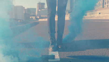 woman-standing-with-smoke-bombs-in-city-street