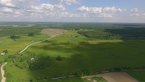country side panoramic landscape in summer time from above and ground with hay rolls and roads