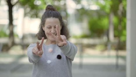 beautiful smiling middle aged woman showing peace signs.