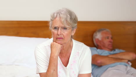 Senior-couple-not-speaking-after-an-argument-on-bed