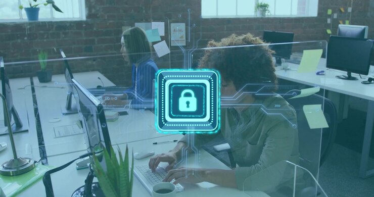 Mid-adult woman and man typing in tech office, initiating pulsing padlock icon protecting network