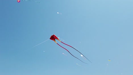 a huge red kite with two tails