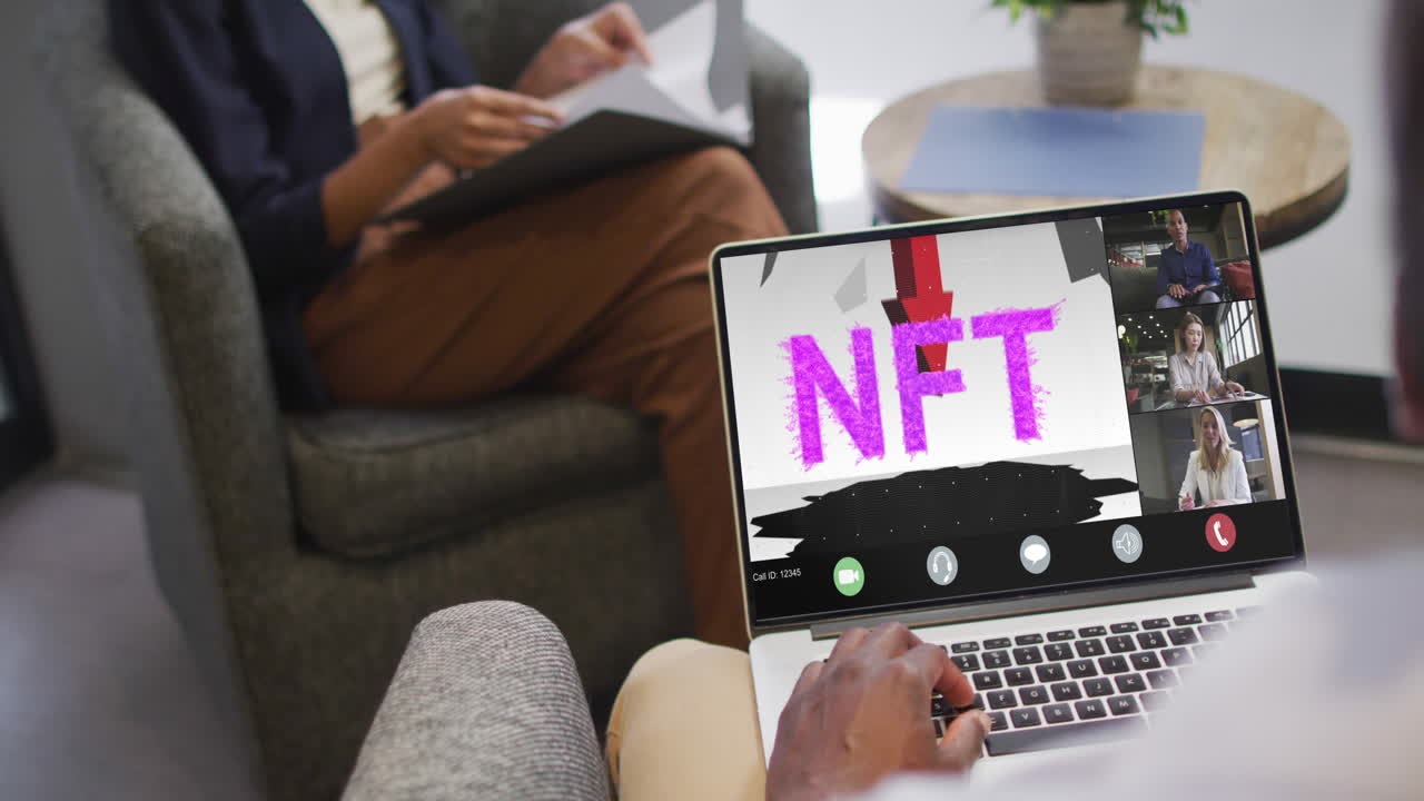 African american businessman using laptop for video call with diverse business colleagues