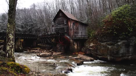 grist mill in west virginia with river flowing