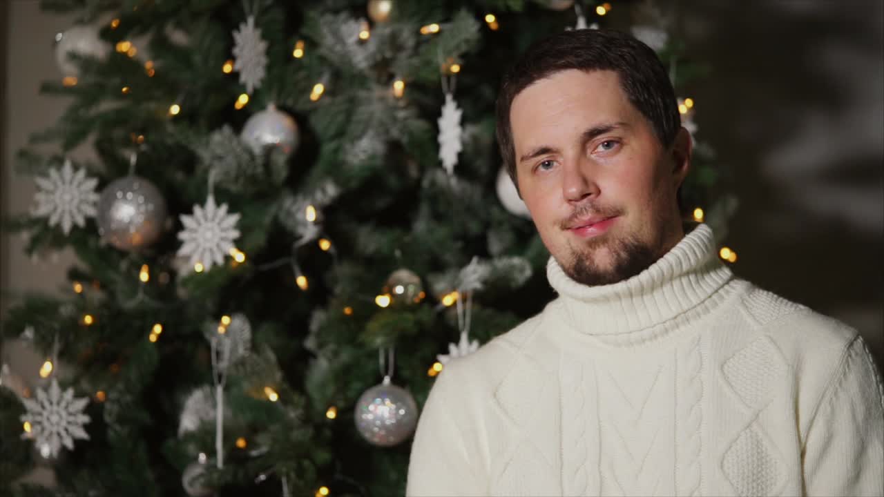 Man in front of Christmas Tree
