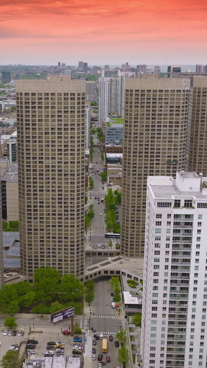 Four similar buildings in the architecture of modern Chicago. Urban panorama of metropolis at the backdrop of pink sky. Vertical video