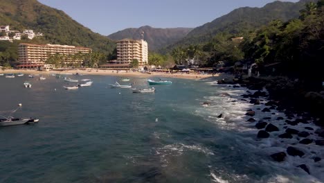 Mismaloya-Beach-The-colorful-Sierra-Madre-Mountains-meet-the-serene-waters-of-the-Mexican-Pacific-Ocean-at-the-beach-of-Mismaloya,-a-quaint-fishing-village-just-15-minutes-south-of-Puerto-Vallarta