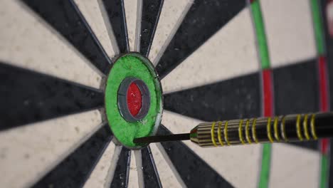 close up of dart board with darts being thrown on it