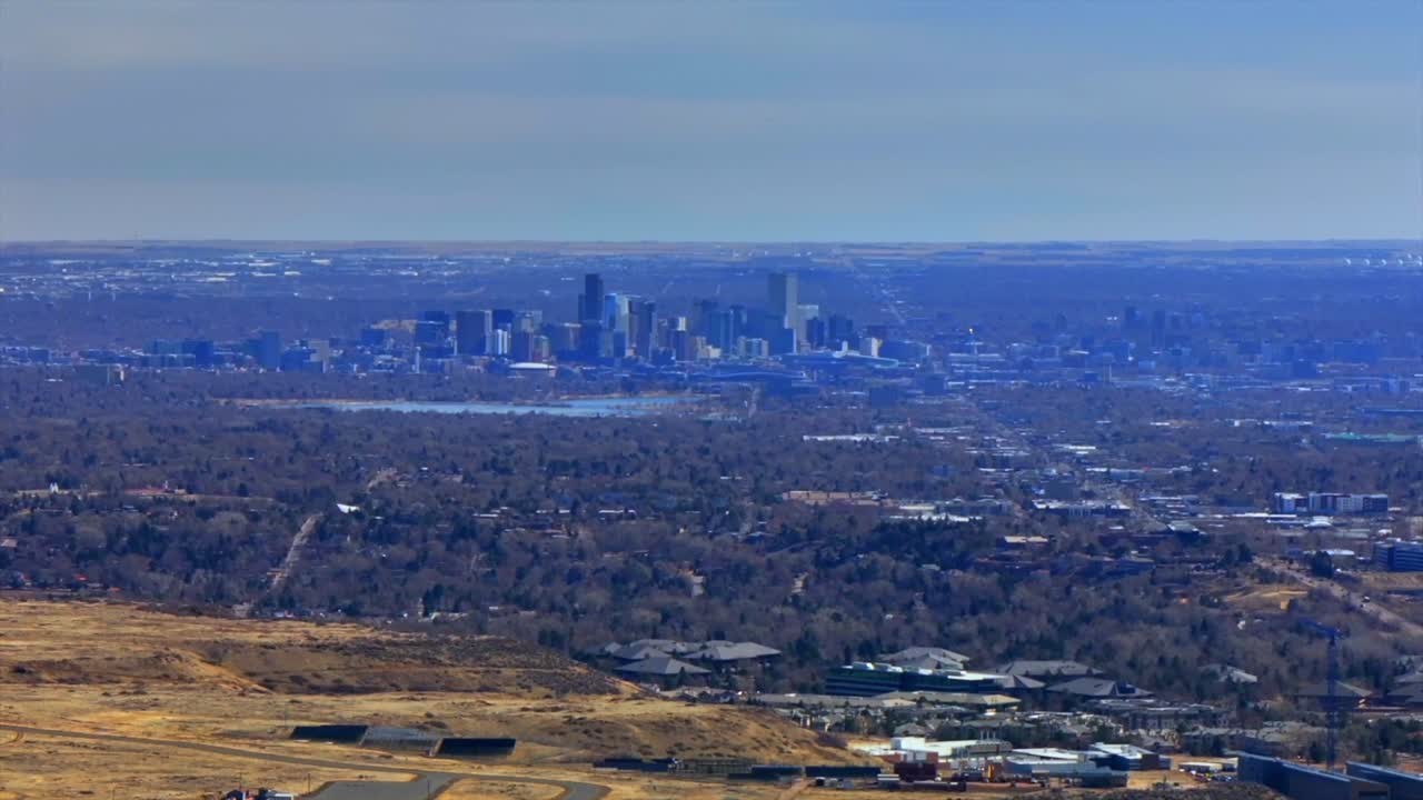 Downtown Denver cityscape from Lookout Mountain Golden North Table Mesa aerial drone Colorado daytime winter sunny clouds neighborhood Front Range Rocky Mountains Arvada Lakewood circle right motion