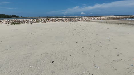 aerial view dolly of walking on the secret beach in vung tau in the morning