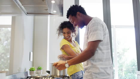 Happy-black-couple-having-fun-cooking-in-a-kitchen