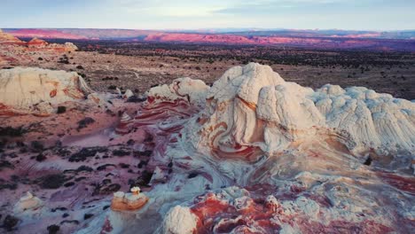 Rough-terrain-with-scenic-cliffs-and-sandy-desert-at-sundown-in-USA