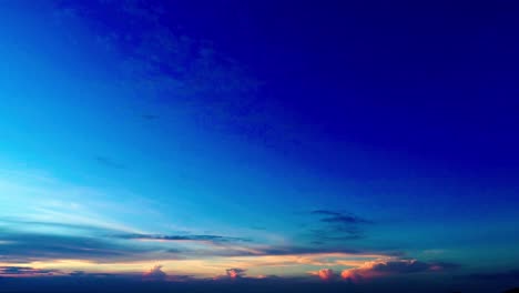 drone shot flying in a sunset sky with a highway in the foreground with sweeping movement of camera