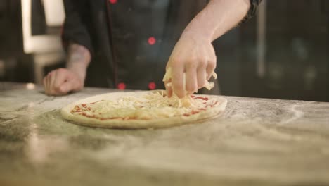 man cooking pizza in the kitchen of restaurant