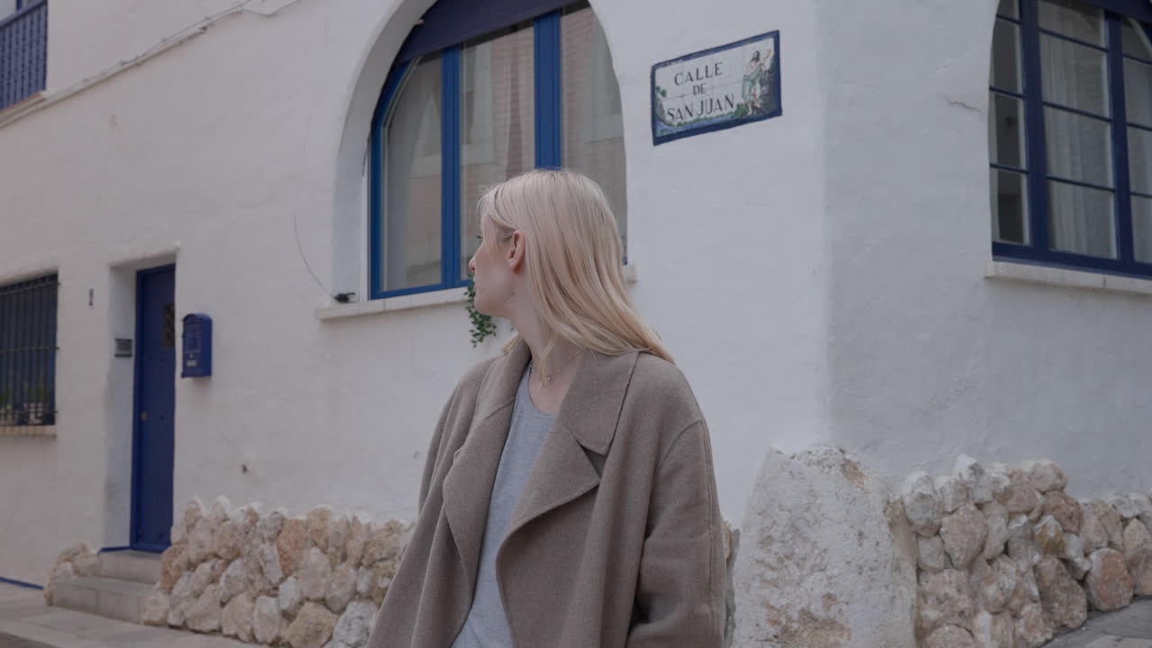 Lost woman Caucasian tourist on white rubble stone old town streets, looking at all directions