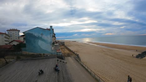 Drohnen-FPV-Actionflug-über-Die-Wellen-Am-Wilden-Surfstrand-Von-Hossegor-Bei-Einem-Bewölkten-Sonnenuntergang