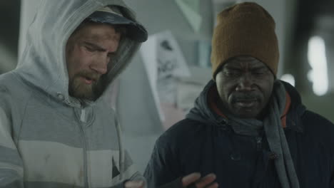 two men experiencing homelessness in an urban setting