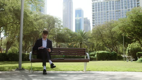 man sitting on the bench of a park