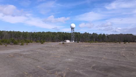 weather radar under a clear blue sky, surrounder by forest