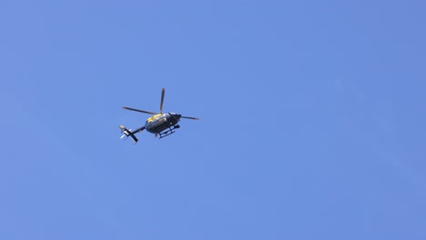 helicopter in flight over clear blue sky