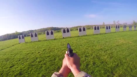 pov as a soldier fires a pistol during a target practice marksmanship competition