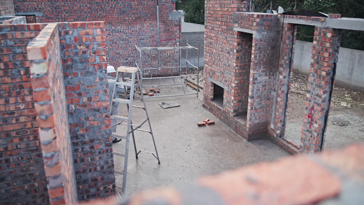 Construction of a brick building with workers