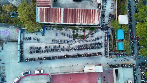 aerial view of an e-scooter and bike parking area in guangzhou, china, showcasing rows of parked electric vehicles. the popularity of eco-friendly transportation in the city, organized parking spaces
