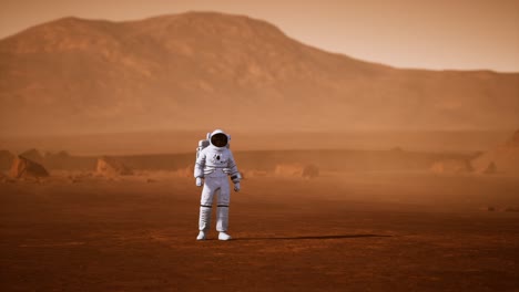 astronauta en la superficie de marte. planeta rojo cubierto de gas y roca