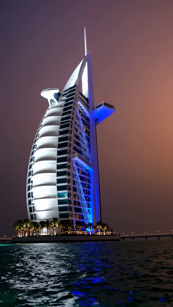 Dramatic low-angle shot of a futuristic skyscraper against a dusky sky, perfect for a video