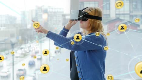 Animation-of-network-of-connections-with-icons-over-woman-wearing-vr-headset