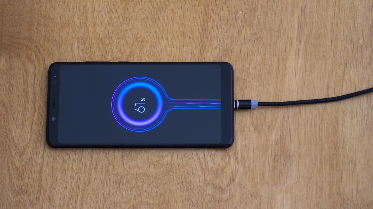Overhead close up view of magnetic charging wire connecting to smart phone