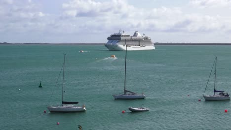 dunmore east waterford tenders ferrying passengers to and from a cruise ship moored in waterford estuary on a summer morning