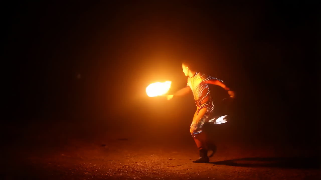Fire Performer in a Luminous Suit at Night