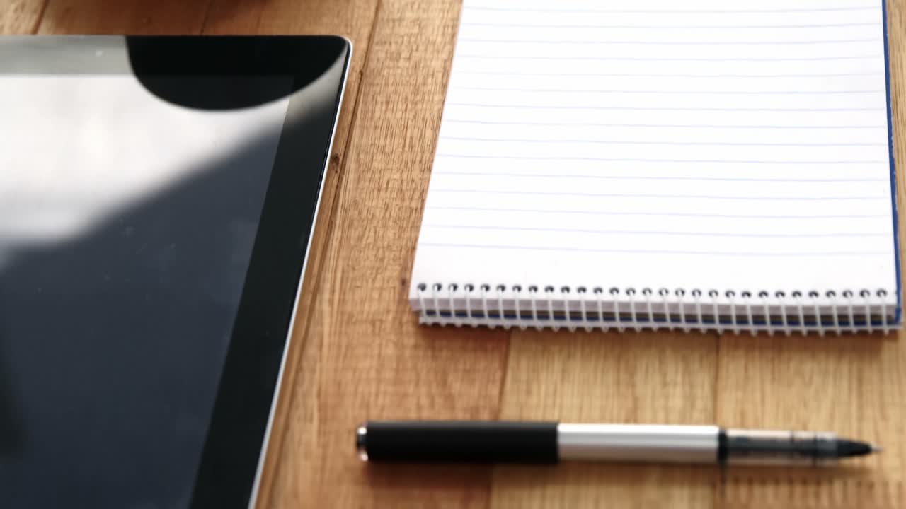 Digital tablet, coffee, diary on pen