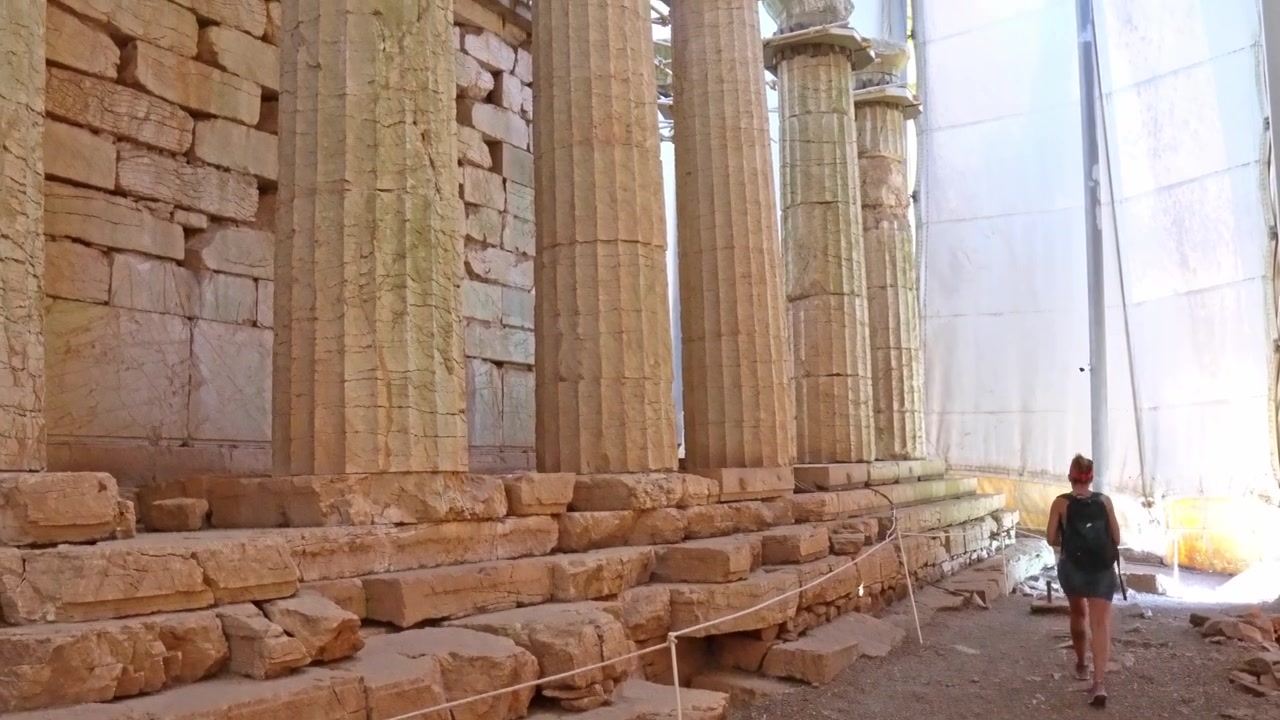 Young woman tourist visiting ancient Bassae Greece archaeological site
